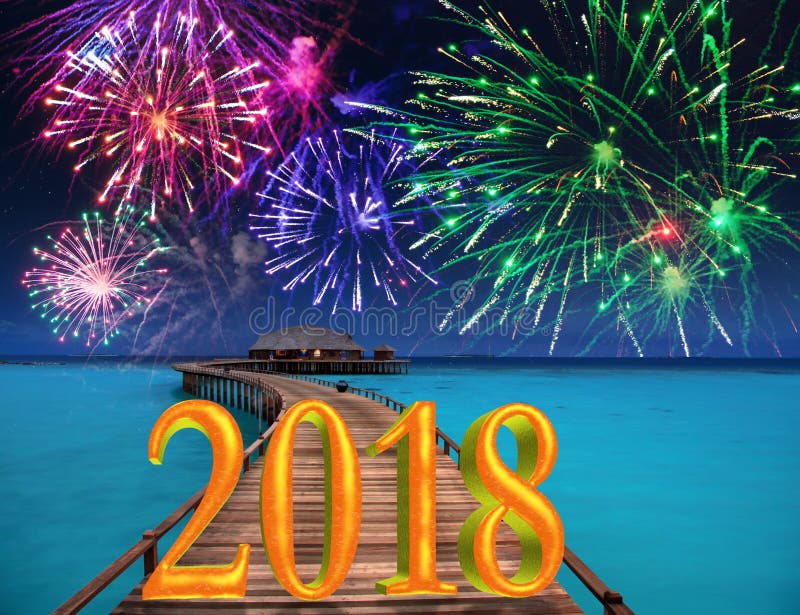 New Year inscription 2018 on the wooden road over the sea and New Year`s fireworks