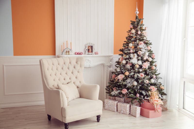 New Year interior with armchair and christmas tree. Pink and ora