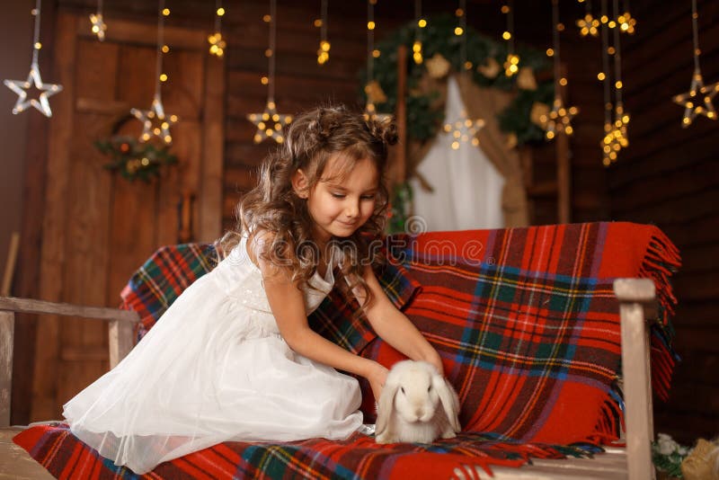 New Year 2020. Merry Christmas, Happy Holidays. A Little Girl In White Dress Sitting On The ...