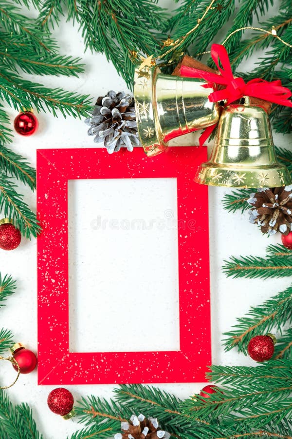 New Year`s background. Christmas jewelry on fir-tree branches, gold spheres, garlands and a red frame for a photo or an inscriptio royalty free stock images New Year`s background. Christmas jewelry on fir-tree branches, gold spheres, garlands and a red frame for a photo or an inscriptio royalty free stock images