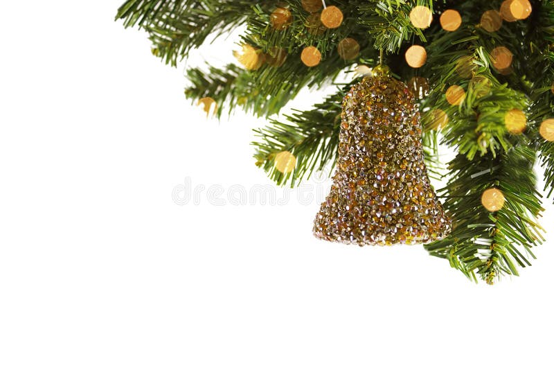 2021 New Year`s toy the gold bells on a fir-tree branch, a holiday a background, the place for the text. Christmas background