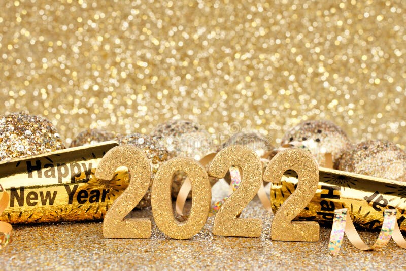 New Years Eve 2022 gold decorations with twinkling background