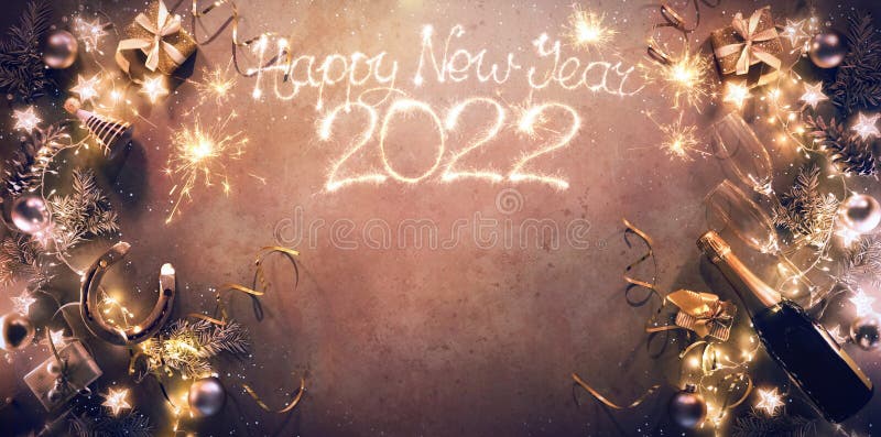 New Years Eve 2022 holiday background with fir branches, horseshoe als lucky charm, champagne bottle and glasses