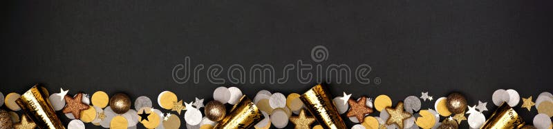 New Years Eve long border banner of confetti, decorations and noisemakers, above view over a black background. New Years Eve long border banner of confetti royalty free stock image New Years Eve long border banner of confetti, decorations and noisemakers, above view over a black background. New Years Eve long border banner of confetti royalty free stock image