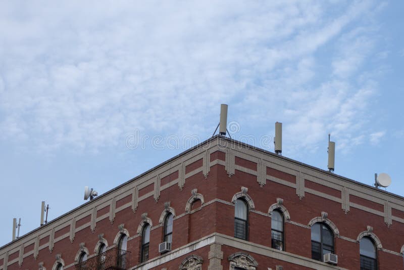 New York building with cellular towers on a their rooftop on a bright sunny day