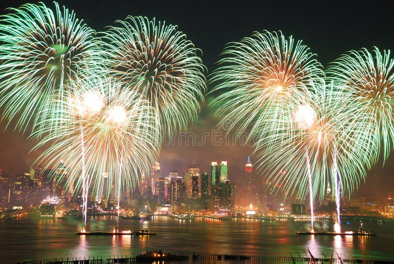 New York City Manhattan July 4th Independence day fireworks show with skyline over Hudson River viewed from New Jersey. New York City Manhattan July 4th Independence day fireworks show with skyline over Hudson River viewed from New Jersey