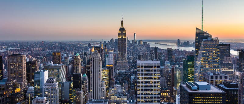 New York City. Manhattan downtown skyline with illuminated Empire State Building and skyscrapers at dusk. USA. New York City. Manhattan downtown skyline with illuminated Empire State Building and skyscrapers at dusk. USA.