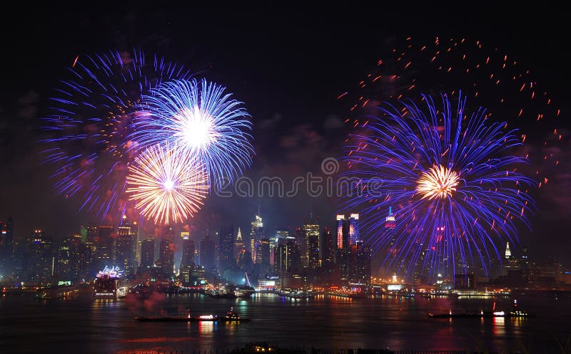 New York City Manhattan July 4th Independence day fireworks show with skyline over Hudson River viewed from New Jersey. New York City Manhattan July 4th Independence day fireworks show with skyline over Hudson River viewed from New Jersey