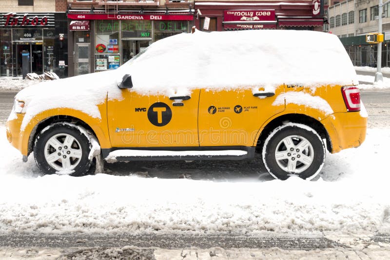 New York City - January 27 - Taxi Cab stands in the snow on the day of the expected blizzard