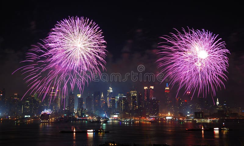 New York City Manhattan July 4th Independence day fireworks show with skyline over Hudson River viewed from New Jersey