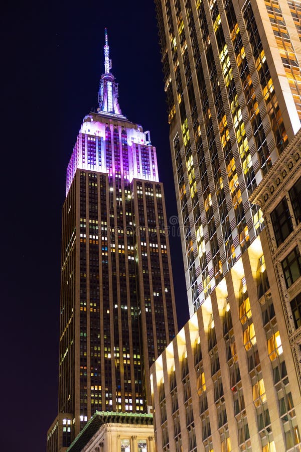 Iconic 103 story skyscraper in the center of Manhattan has changing light colors on its upper section throughout the night. Iconic 103 story skyscraper in the center of Manhattan has changing light colors on its upper section throughout the night.