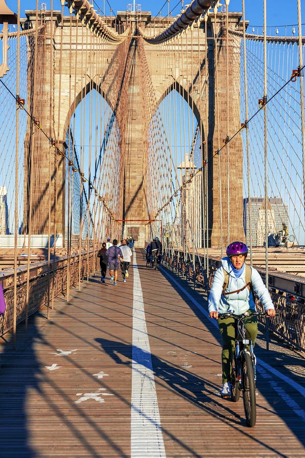 NEW YORK CITY - OCTOBER 26: The pedestrian walkway along The Brooklyn Bridge in New York City on October 26, 2013. Approximately 4,000 pedestrians and 3,100 cyclists cross this historic bridge each day