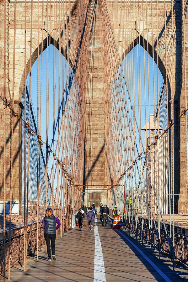 NEW YORK CITY - OCTOBER 26: The pedestrian walkway along The Brooklyn Bridge in New York City on October 26, 2013. Approximately 4,000 pedestrians and 3,100 cyclists cross this historic bridge each day