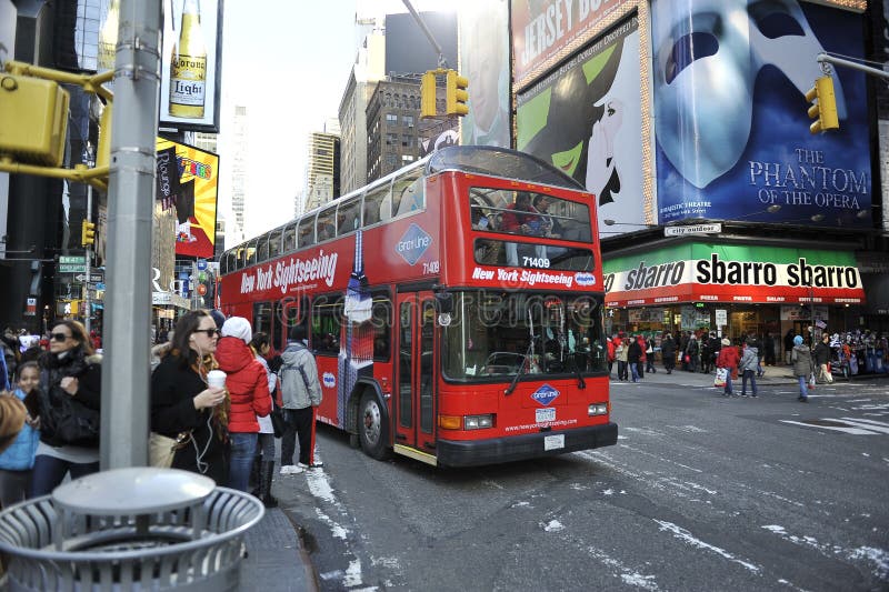 A tour bus driving thought times square in new York city. A tour bus driving thought times square in new York city