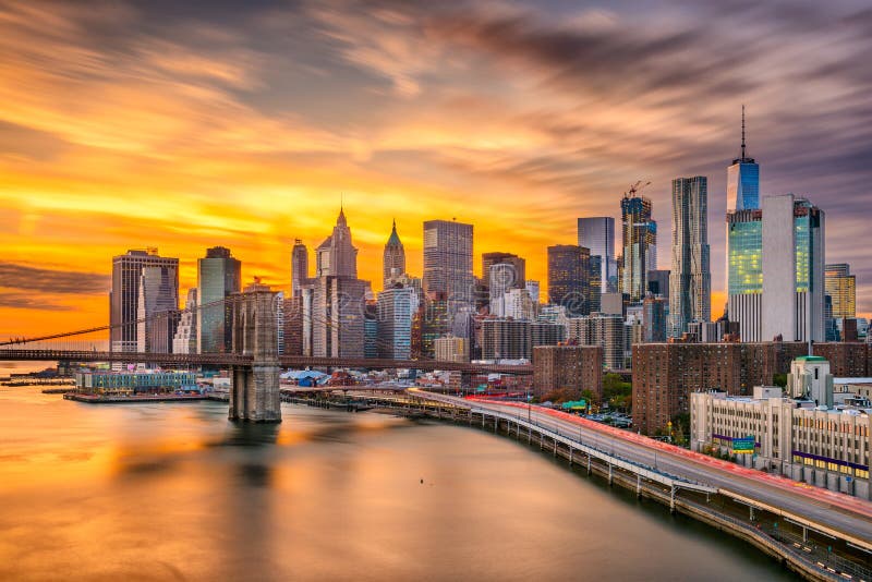 New York, New York, USA lower Manhattan skyline over the East River with the Brooklyn Bridge after sunset. New York, New York, USA lower Manhattan skyline over the East River with the Brooklyn Bridge after sunset.