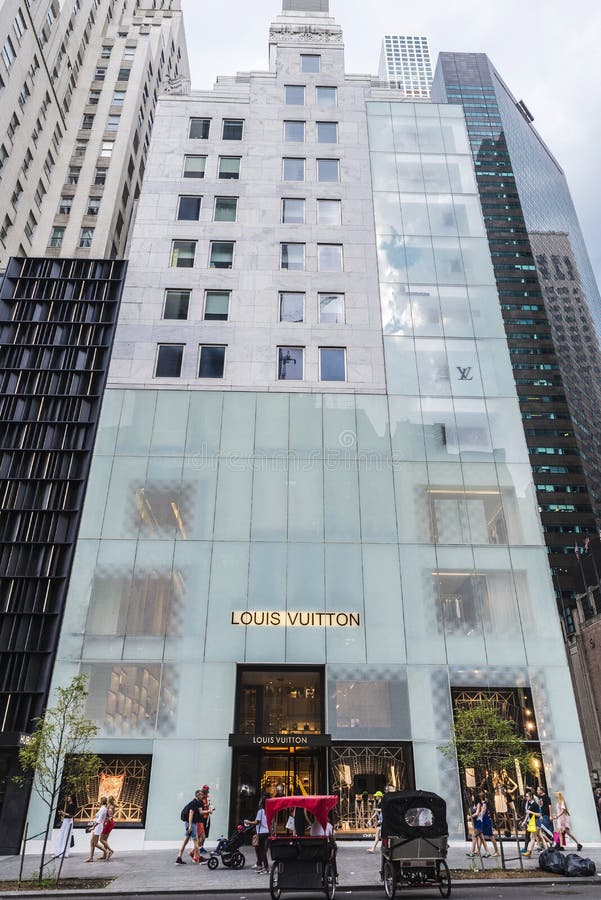 Pedestrians walking past the Louis Vuitton store on 5th avenue Stock Photo  - Alamy