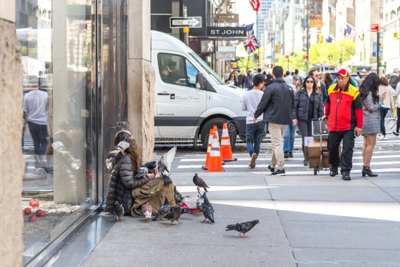 new-york-city-usa-may-young-homeless-woman-many-doves-asking-charity-passers-th-avenue-looking-151943511.jpg