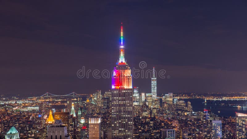 Clear night above Empire State Building lights. New York City at bottom is 1 World Trade Center called Freedom tower. Clear night above Empire State Building lights. New York City at bottom is 1 World Trade Center called Freedom tower.