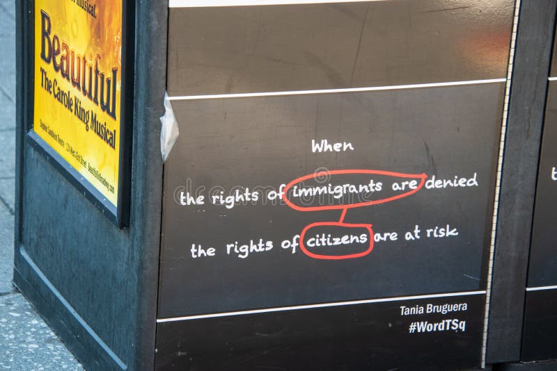 Recycling trash can in Times Square Manhattan with a motivational saying about immigrants being denied the rights of citizens. New York, NY - April 3, 2019 royalty free stock photos Recycling trash can in Times Square Manhattan with a motivational saying about immigrants being denied the rights of citizens. New York, NY - April 3, 2019 royalty free stock photos