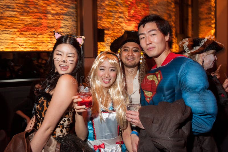 NEW YORK, NY - OCTOBER 31: Guests in mascarade costumes posing at The Fashion Party during Halloween event at the Venue 409 on October 31, 2014 in New York City. NEW YORK, NY - OCTOBER 31: Guests in mascarade costumes posing at The Fashion Party during Halloween event at the Venue 409 on October 31, 2014 in New York City.