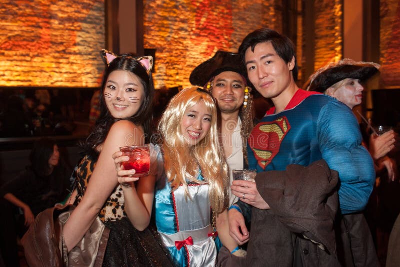 NEW YORK, NY - OCTOBER 31: Guests in mascarade costumes posing at The Fashion Party during Halloween event at the Venue 409 on October 31, 2014 in New York City. NEW YORK, NY - OCTOBER 31: Guests in mascarade costumes posing at The Fashion Party during Halloween event at the Venue 409 on October 31, 2014 in New York City.