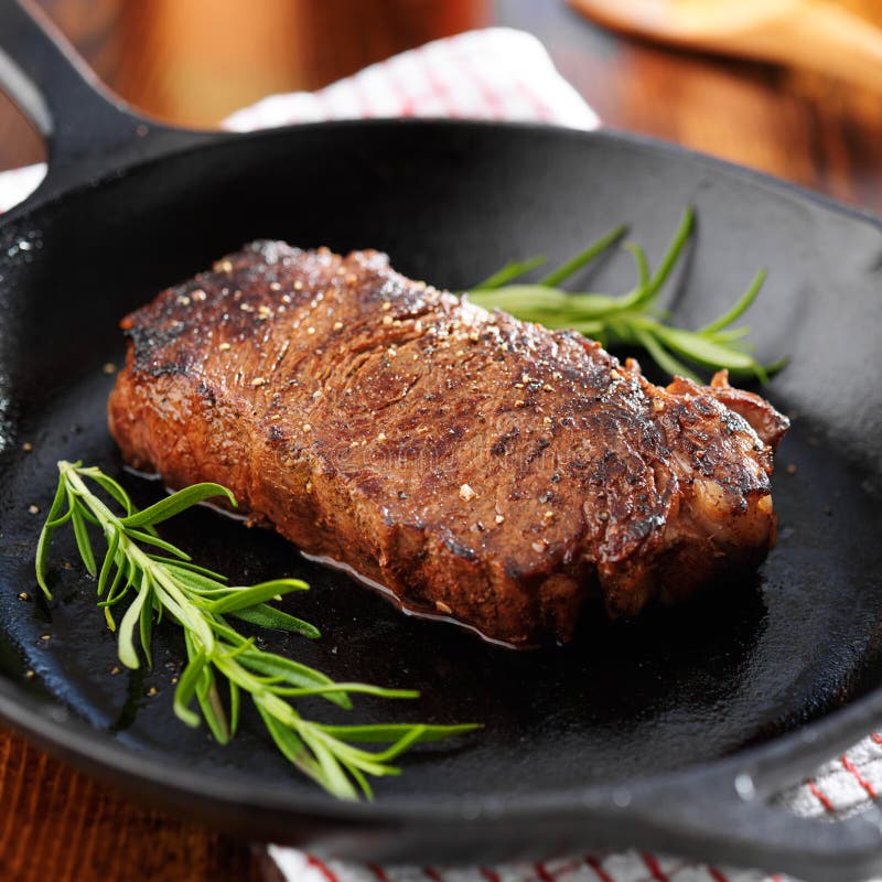 New york strip steak cooked in iron skillet stock photo New york strip steak cooked in iron skillet stock photo