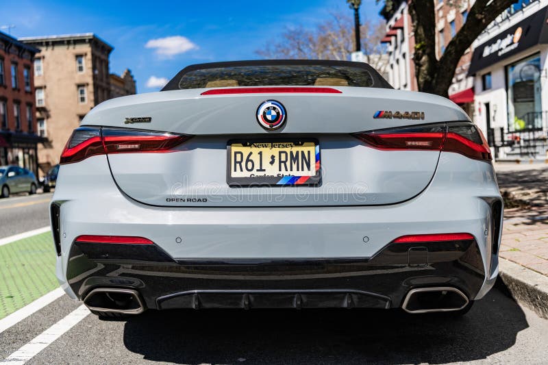 New York City, USA - March 31, 2024: BMW 4 sport gran coupe convertible car parked outdoor, back view. New York City, USA - March 31, 2024: BMW 4 sport gran coupe convertible car parked outdoor, back view.