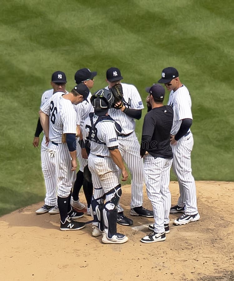 New York Yankees pitcher, Clay Holmes (center) holds his glove over his mouth to frustrate lip-readers as he confers with his manager, Aaron Boone (dark shirt) and infielders DJ LeMahieu (No. 26), Ben Rortvedt (catcher wearing gear), Anthony Rizzo (right), and others. This came at a crucial time in the MLB American League contest, in the 9th inning with the Yanks up by 3 but with the Kansas City Royals having the potentially tying run at the plate. Holmes settled down and got the final out as the Yankees prevailed 5-2 in a home game at Yankee Stadium in the Bronx, New York, on July 22, 2023. New York Yankees pitcher, Clay Holmes (center) holds his glove over his mouth to frustrate lip-readers as he confers with his manager, Aaron Boone (dark shirt) and infielders DJ LeMahieu (No. 26), Ben Rortvedt (catcher wearing gear), Anthony Rizzo (right), and others. This came at a crucial time in the MLB American League contest, in the 9th inning with the Yanks up by 3 but with the Kansas City Royals having the potentially tying run at the plate. Holmes settled down and got the final out as the Yankees prevailed 5-2 in a home game at Yankee Stadium in the Bronx, New York, on July 22, 2023.