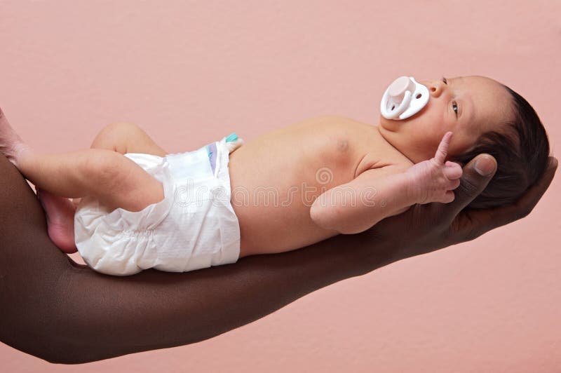 Newborn baby on the arm stock image