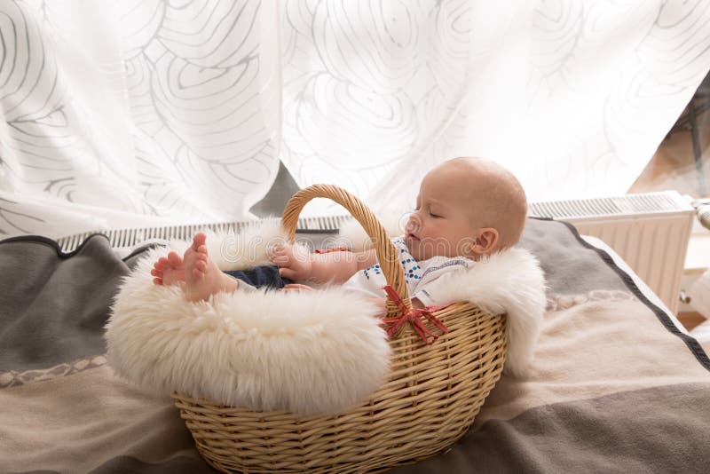 Newborn baby in the basket stock image. Image of hands 52809053