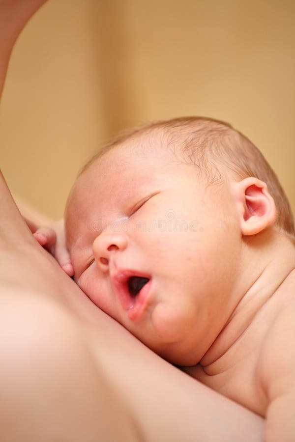 Newborn baby boy asleep after feeding