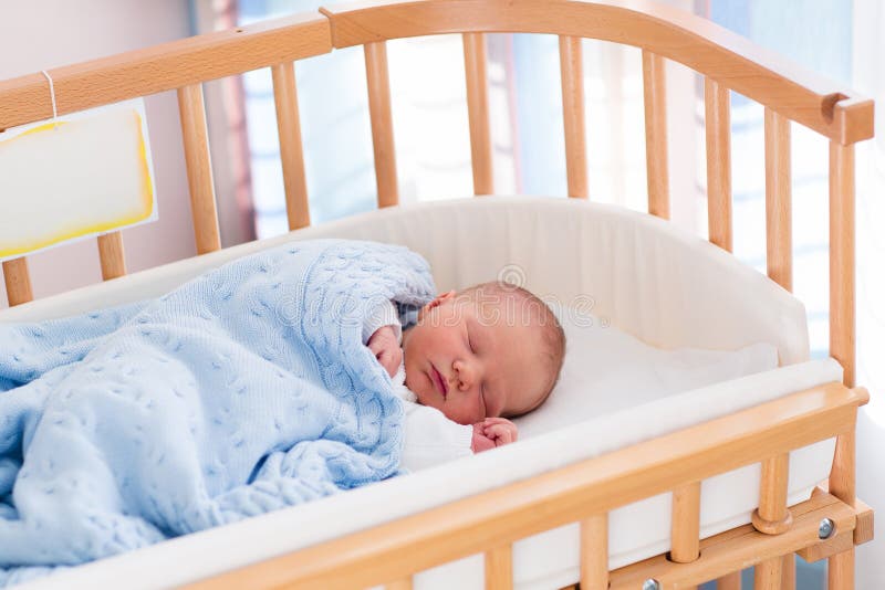 Newborn baby boy in hospital cot