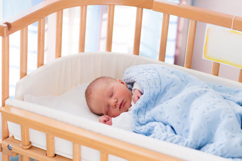 Newborn baby boy in hospital cot