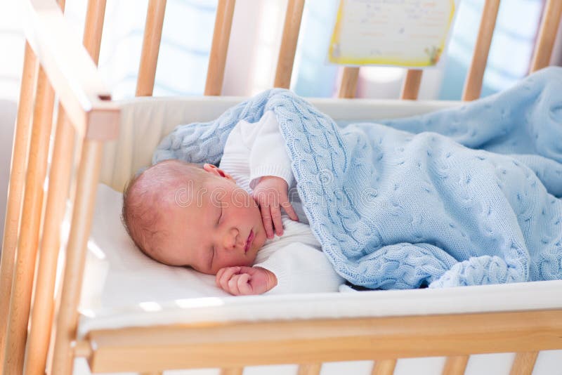 Newborn baby boy in hospital cot