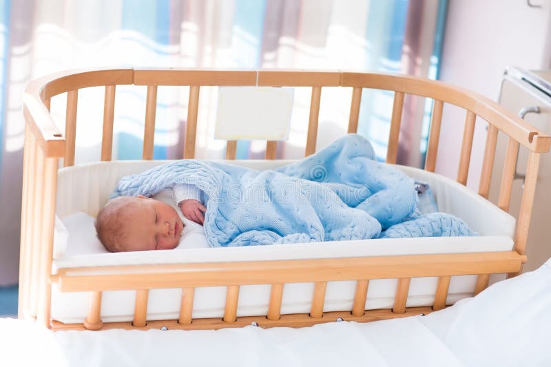 Newborn baby boy in hospital cot