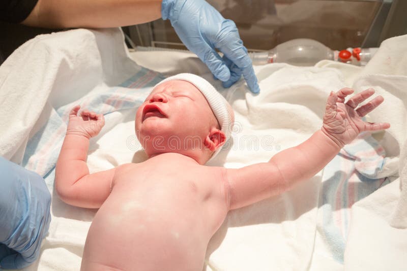 Newborn Baby on Exam Table stock photo Newborn Baby on Exam Table stock photo