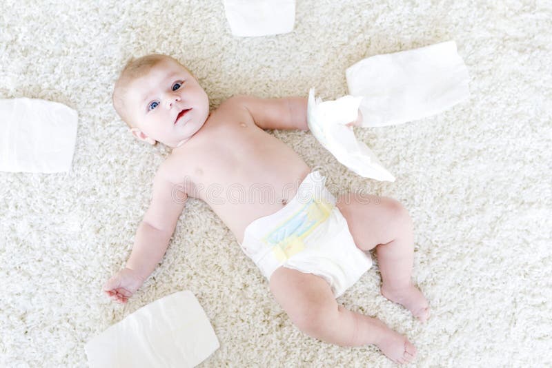 Newborn baby girl with diapers. Dry skin and nursery