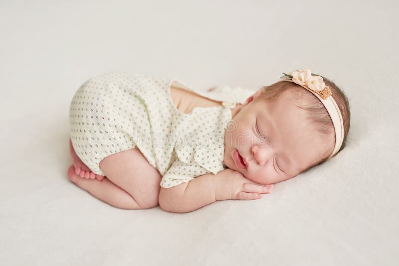 Newborn baby girl sleep on a light background