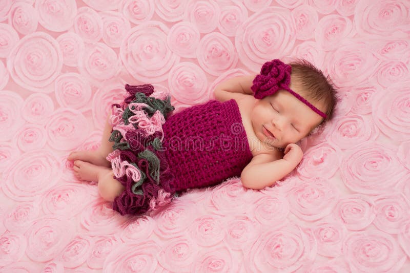 Newborn Baby Girl Wearing a Crocheted Romper