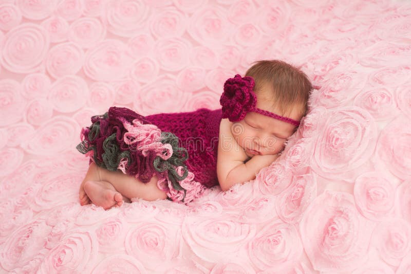 Newborn Baby Girl Wearing a Crocheted Romper