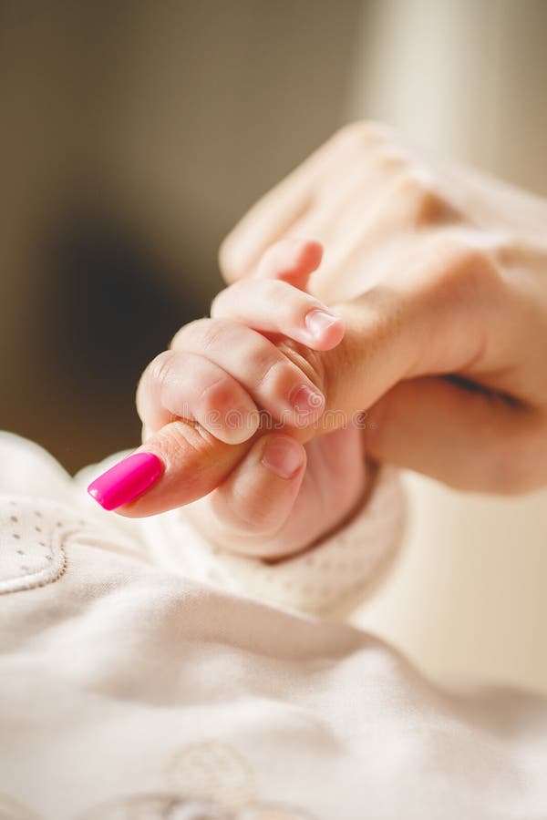 Newborn baby holding mother's finger royalty free stock photo Newborn baby holding mother's finger royalty free stock photo