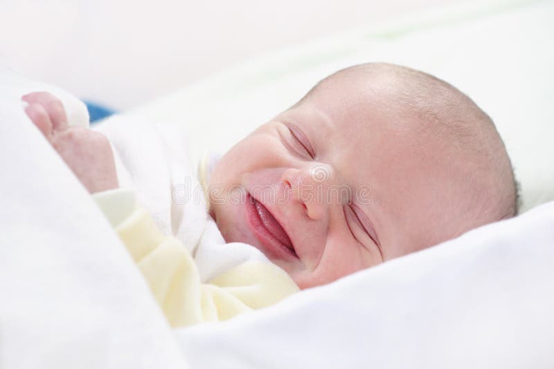 Newborn baby laughing stock image