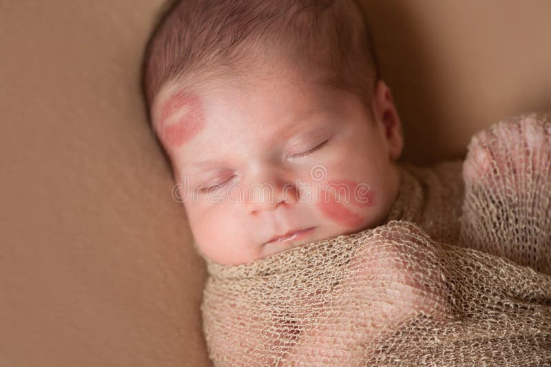 Newborn Baby with Lipstick Kisses on Face