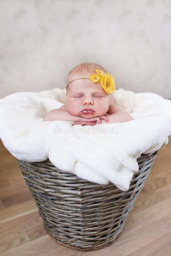 Newborn baby in a round wicker basket royalty free stock photography Newborn baby in a round wicker basket royalty free stock photography