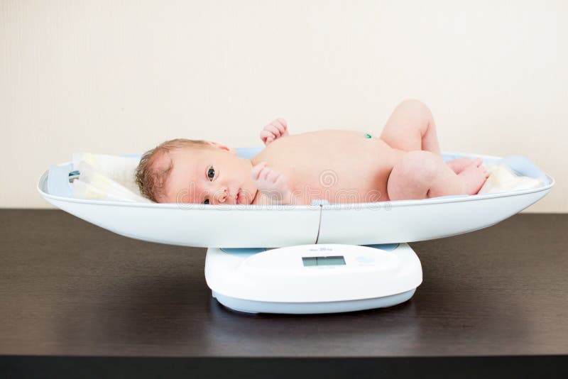 Newborn Baby On Scale. Physical Development Concept Photo Of Child Health  Care. Copy Space Stock Photo, Picture and Royalty Free Image. Image  45837323.