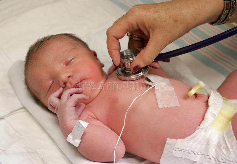 Newborn being checked