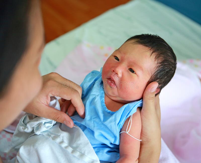 Newborn infant on mother hand and open eyes stock photos Newborn infant on mother hand and open eyes stock photos