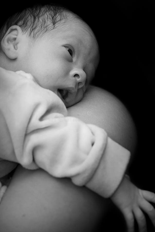Newborn on mothers shoulder