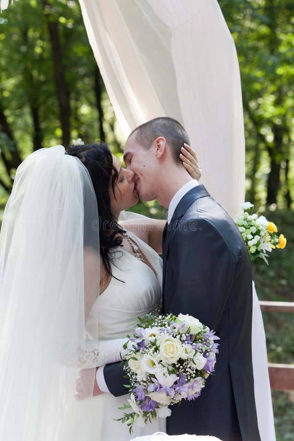 Newlymarried couple kiss stock photo. Image of good 26700848
