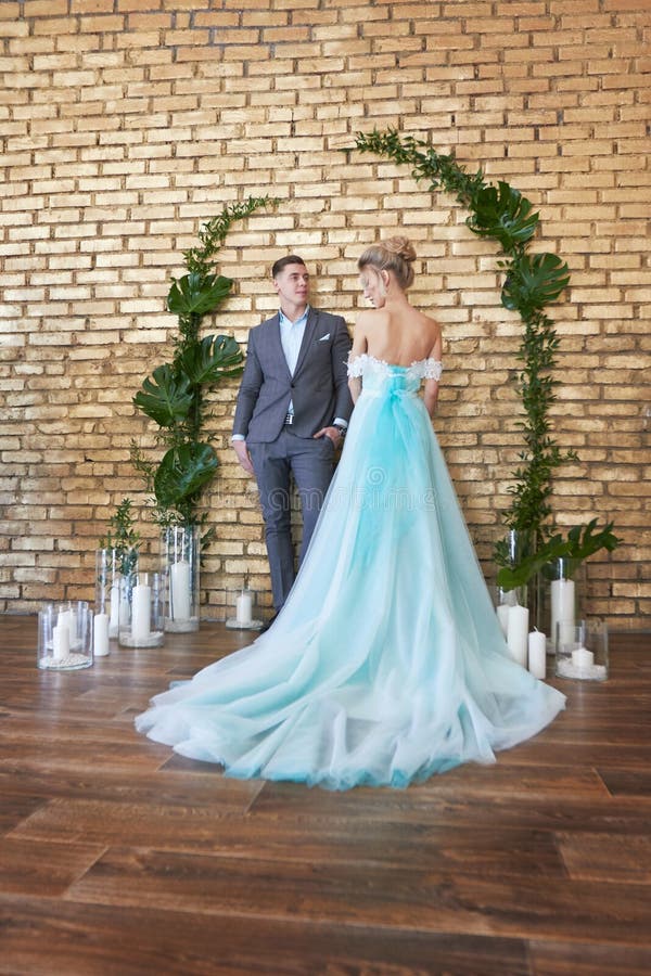 Newly married couple, loving couple before the wedding. Man and woman loving each other. Bride in the turquoise dress and groom